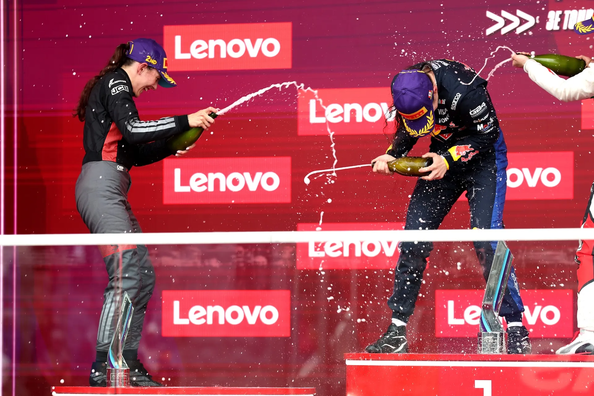 MONTREAL, QUEBEC - MAY 24: Race winner Alisha Palmowski of Great Britain and Campos Racing (21) and Second placed Emma Felbermayr of Austria and Rodin Motorsport (5) and Audi F1 Team celebrate with Champagne on the podium during F1 Academy Round 2, race 3 at Circuit Gilles Villeneuve on May 24, 2026 in Montreal, Quebec. (Photo by Brett Farmer/LAT Images)