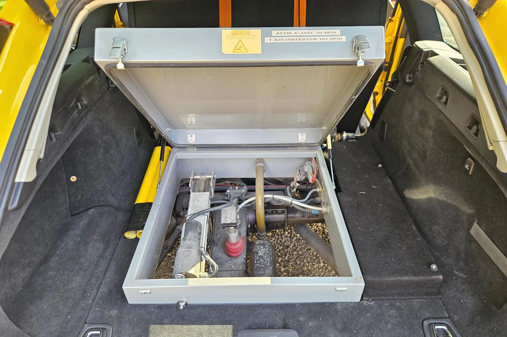 Yellow Volvo V90 with SARSYS airport runway friction testing equipment